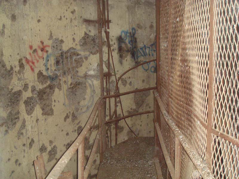 Bullet-riddled walls and walkways of bird crap